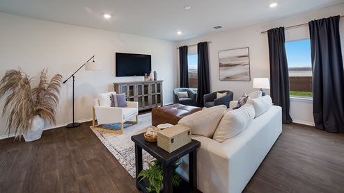 Spacious living area with large windows and hard surface flooring