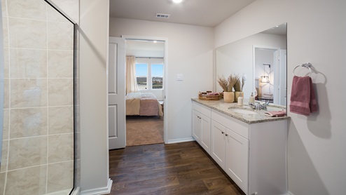 Spacious primary bathroom with plenty of counterspace, single vanity sink and hard surface flooring.