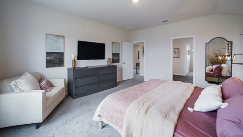 Spacious primary bedroom with quality carpet and ensuite bathroom.