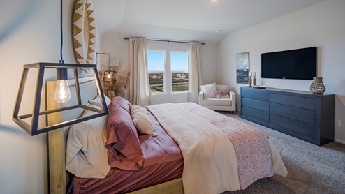 Spacious primary bedroom with large windows and walk-in closet.