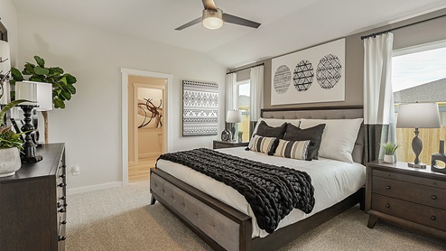 Midtown Primary bedroom with carpeted flooring and bathroom access.