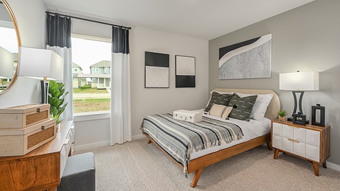 Midtown Model secondary bedroom with carpeted flooring and window.