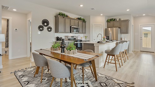 Midtown Model Dining with view to kitchen and vinyl plank flooring.
