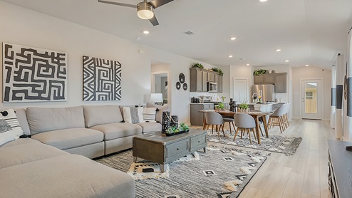 Midtown Model living room with view to kitchen and back door.