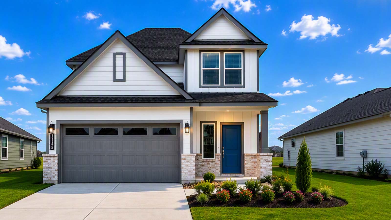 Midtown front elevation of a two-story white farmhouse-style home with dark trim, a two-car garage