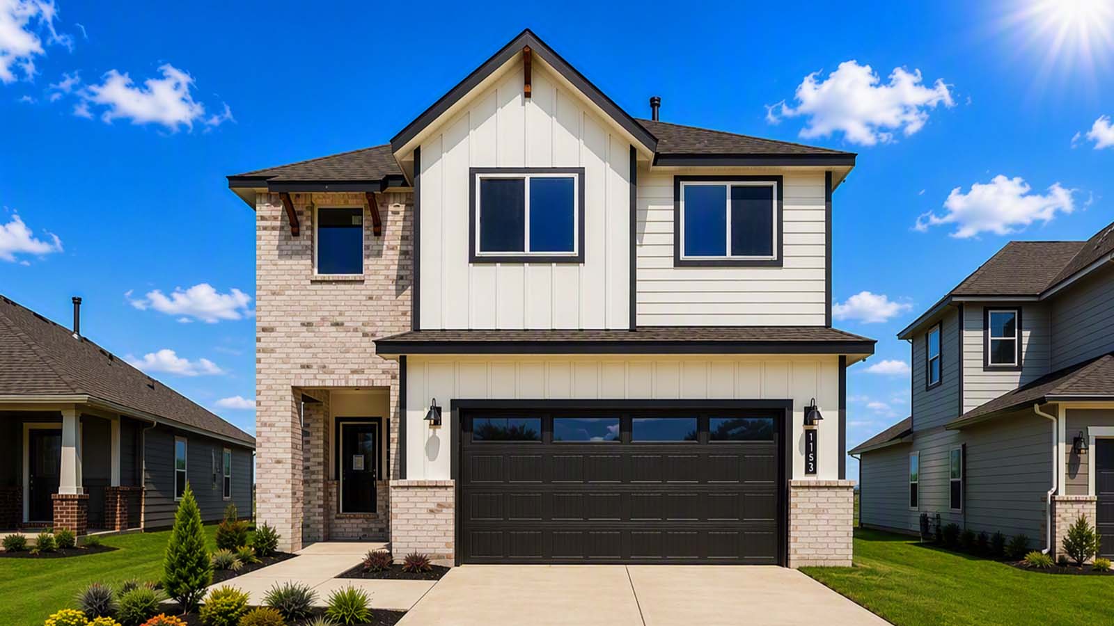 Midtown front elevation of a two-story white farmhouse-style home with dark trim, a two-car garage