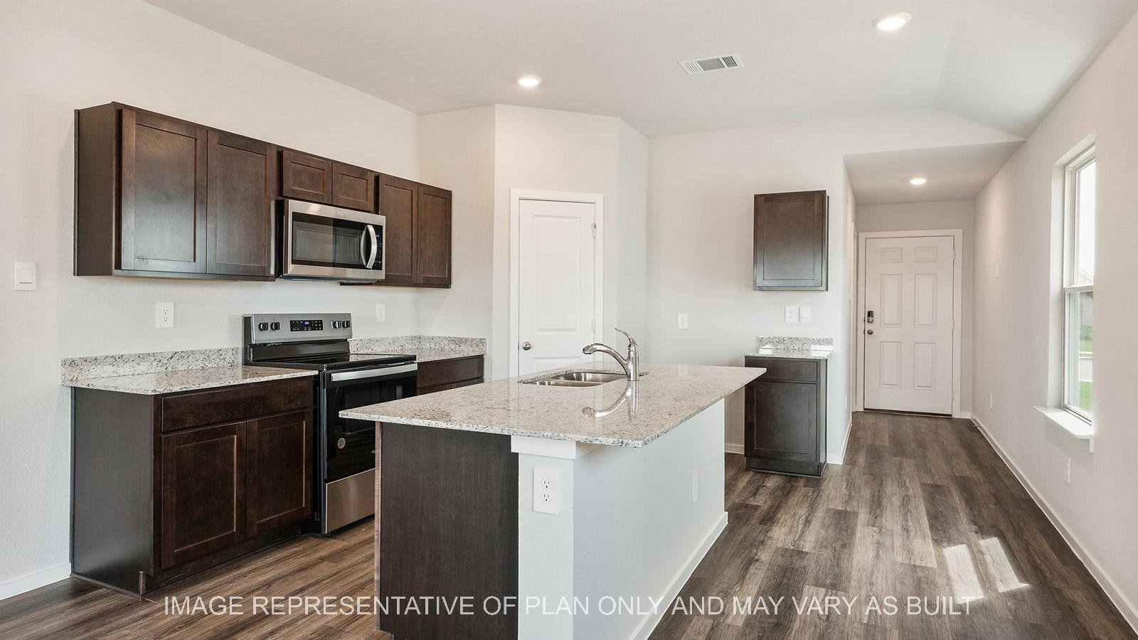 Amber kitchen with window and view to entryway.