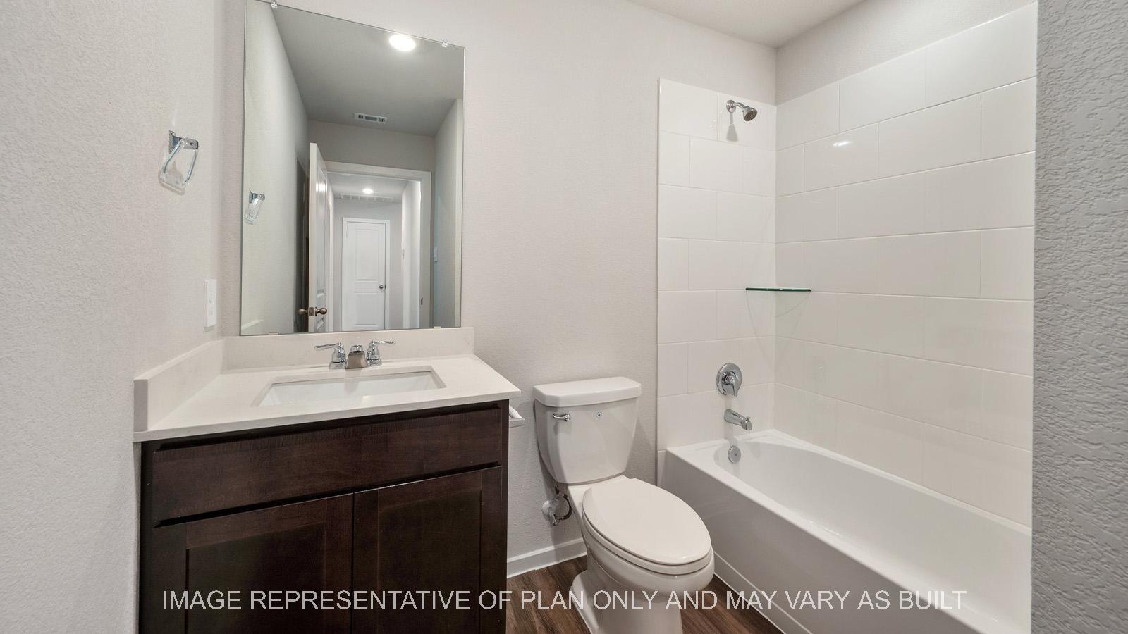 Amber secondary bathroom with quarts countertops and ceramic tile shower/tub surround.