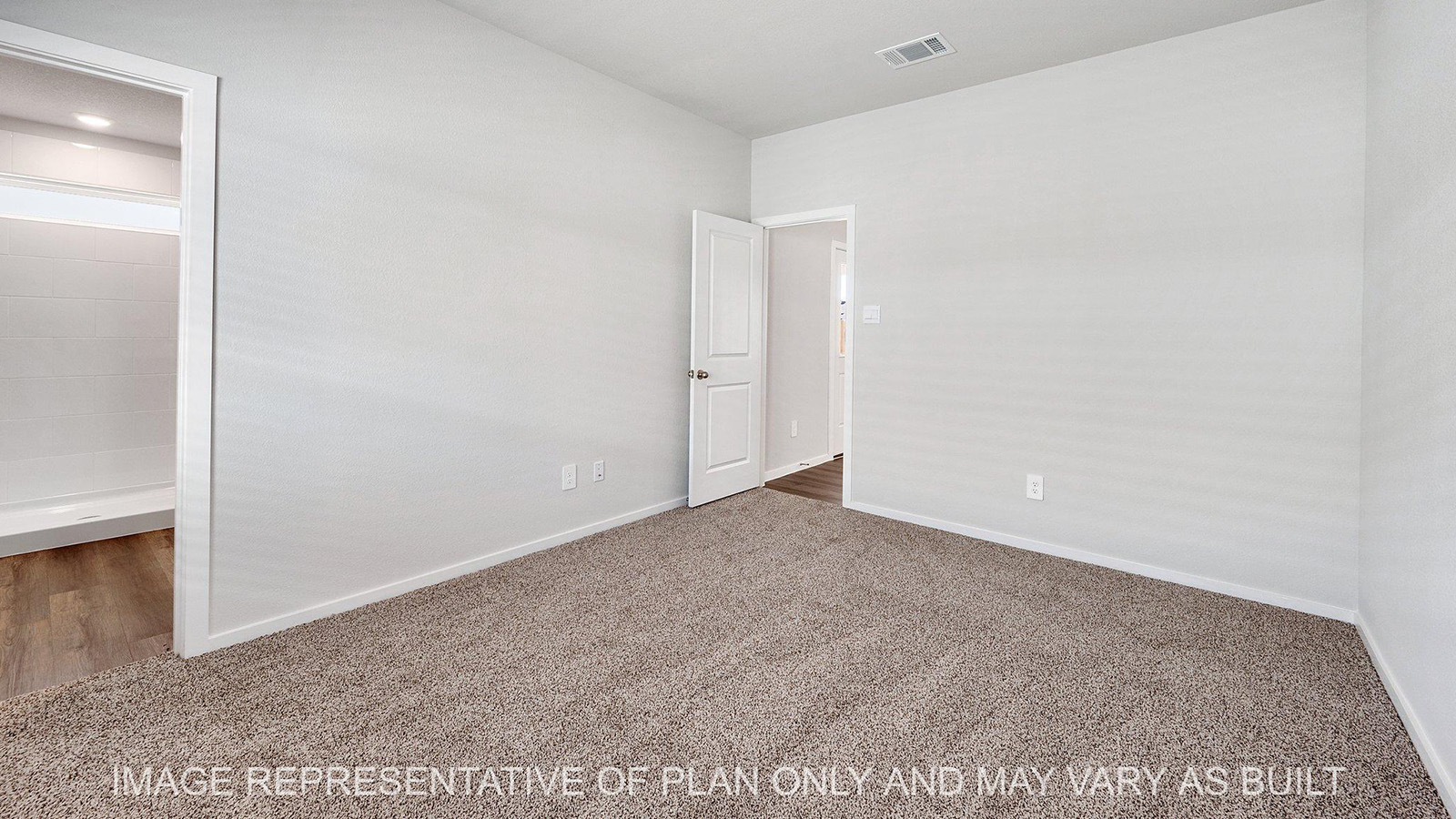 Brooke primary bedroom with carpeted flooring and bathroom access.
