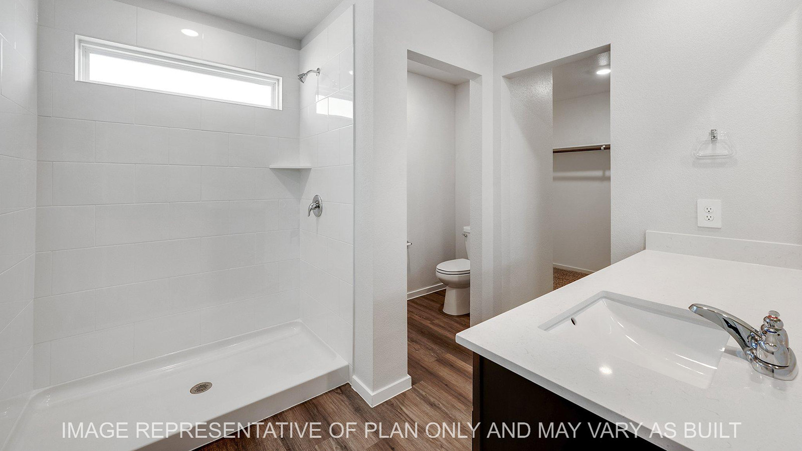Brooke primary bathroom with vinyl plank flooring, quartz countertops, and ceramic tile shower surround.