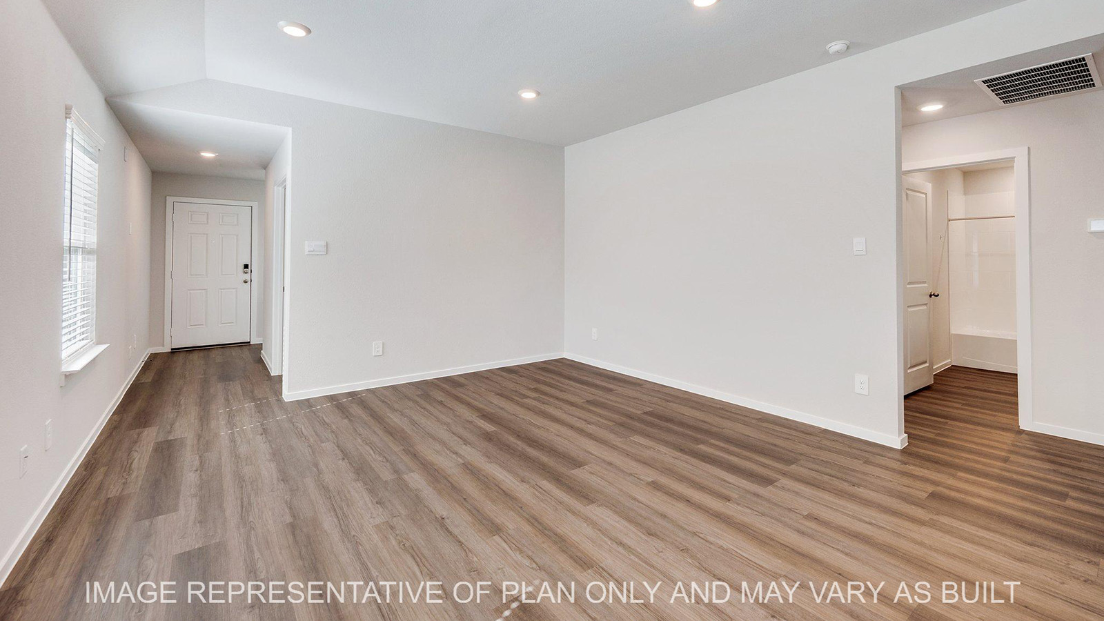 Brooke open-concept living room with vinyl plank flooring and windows.