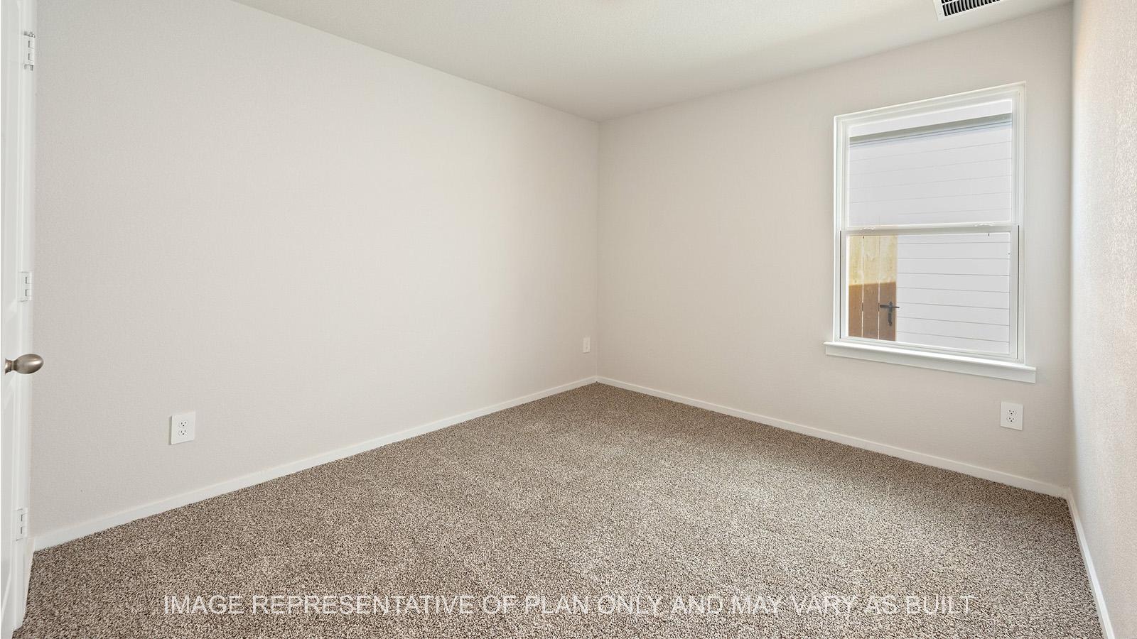 Caroline secondary bedroom with carpeted flooring and window.