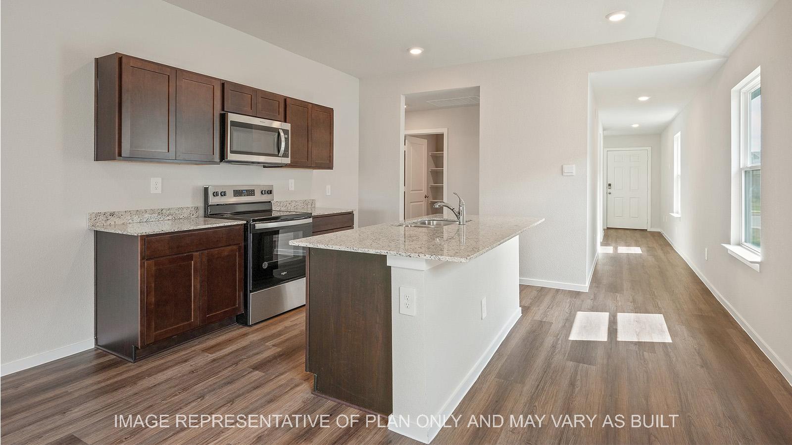 Caroline kitchen with island and stainless steel appliances.