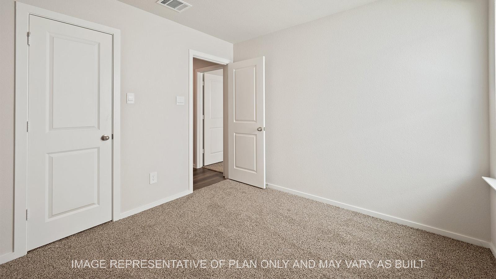 Caroline secondary bedroom with carpeted flooring and closet.