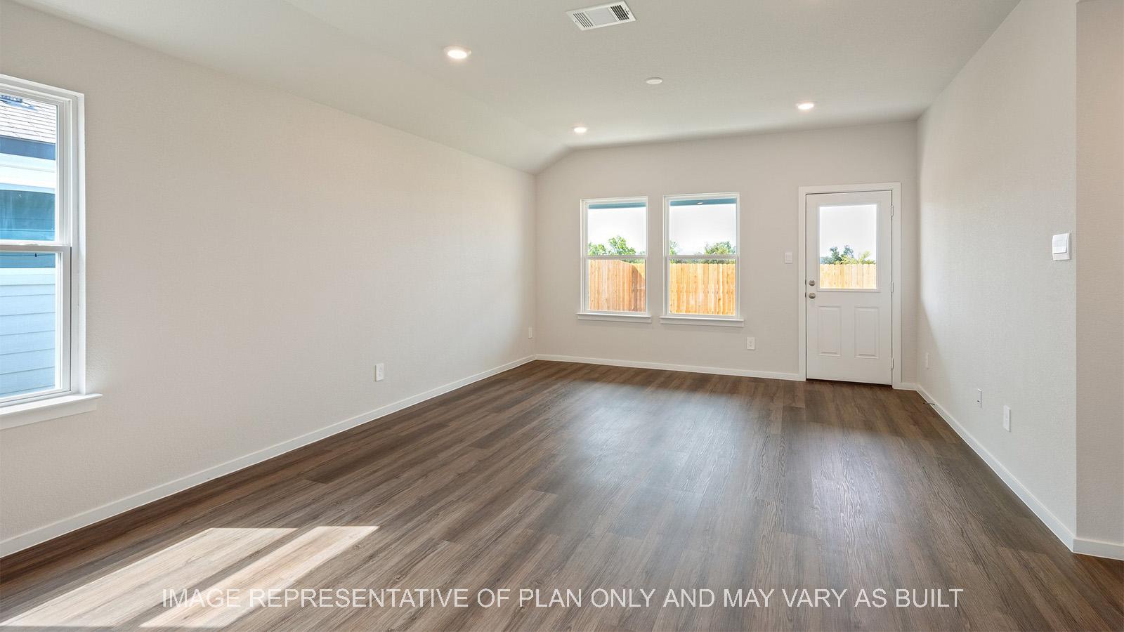 Caroline open concept living with vinyl plank flooring, windows, and back door.