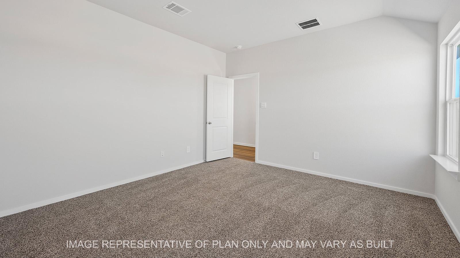 Diana primary bedroom with carpeted flooring and view to door.