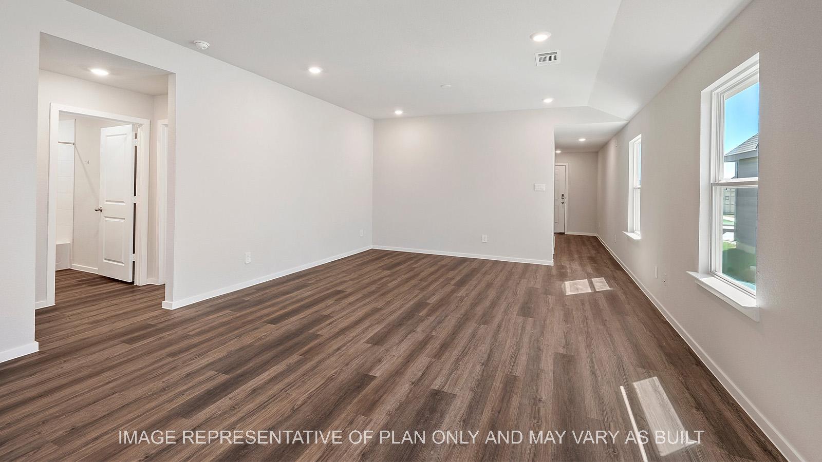 Diana open-concept living room with dark brown vinyl plank flooring.