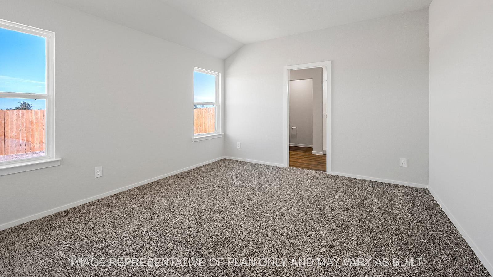 Diana primary bedroom with carpet and windows.