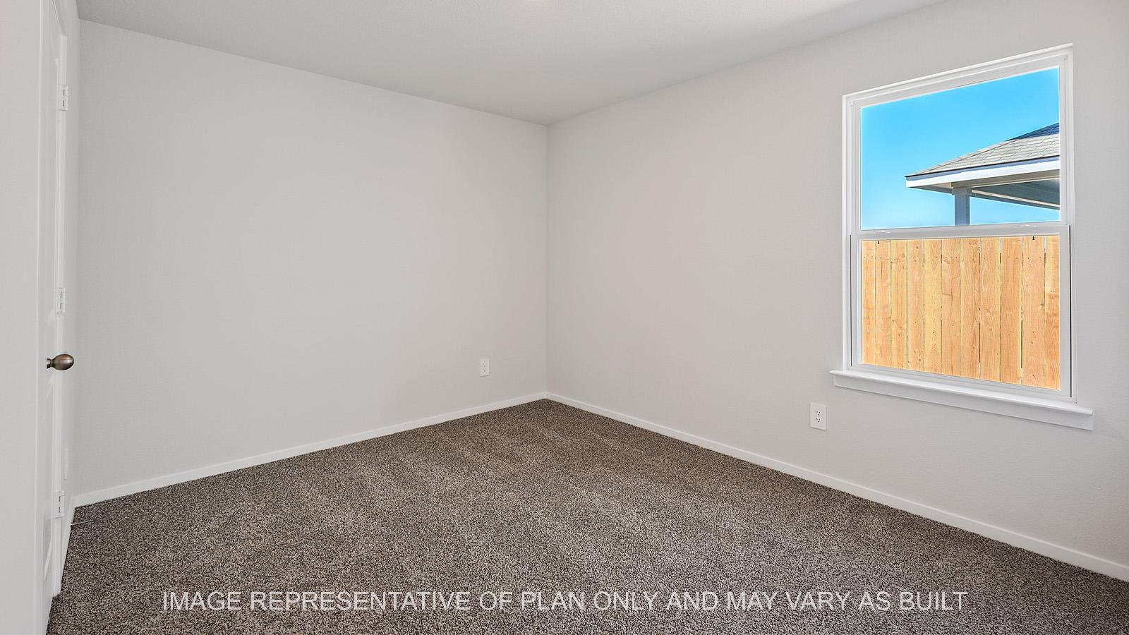Diana secondary bedroom with carpet and window.