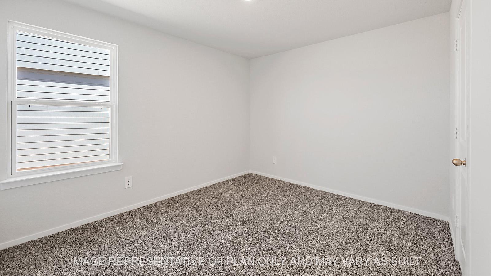 Diana secondary bedroom with walk-in closet, carpeted flooring, and window.
