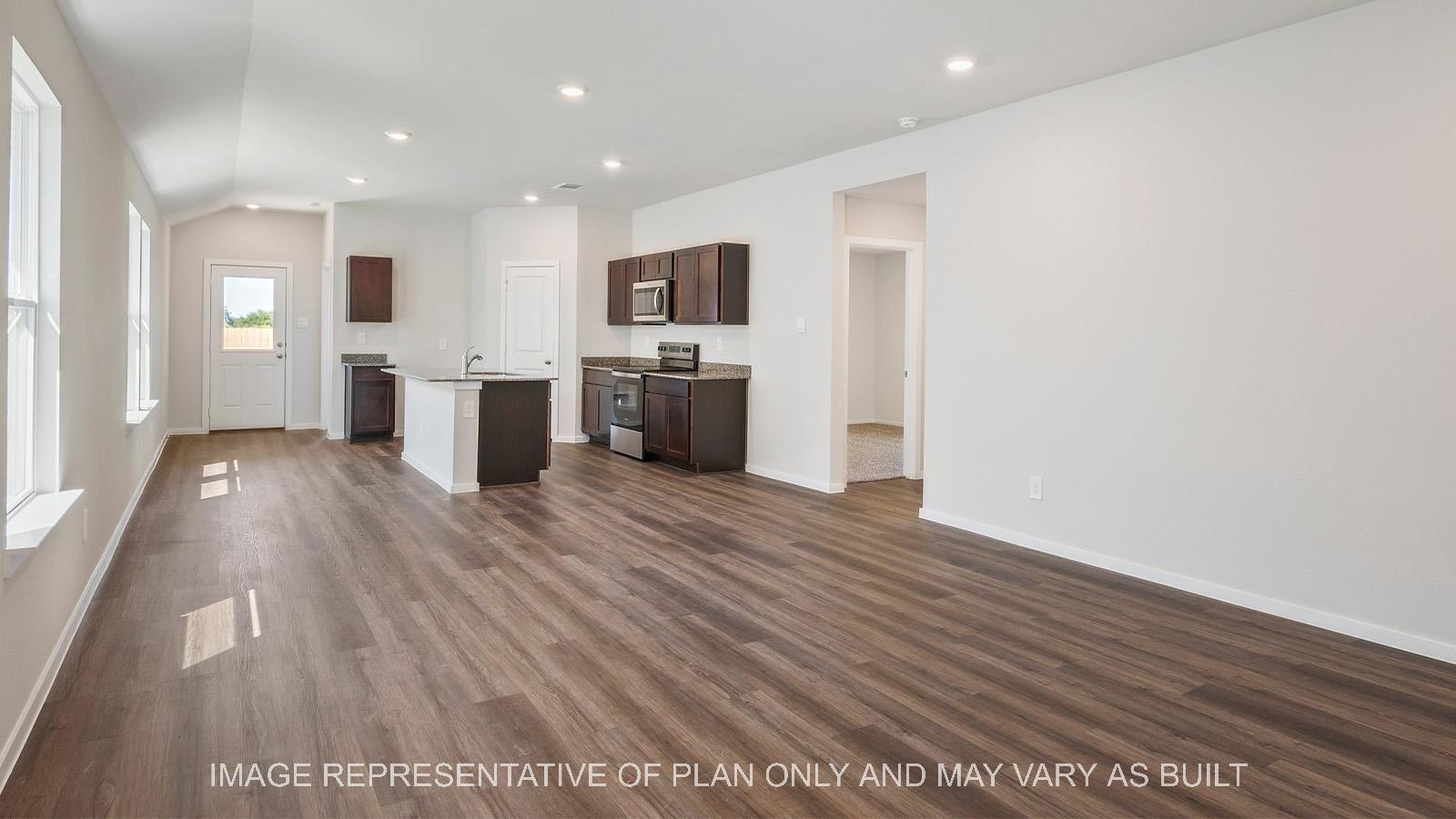 Diana open-concept living room with view to kitchen and secondary bedroom access.