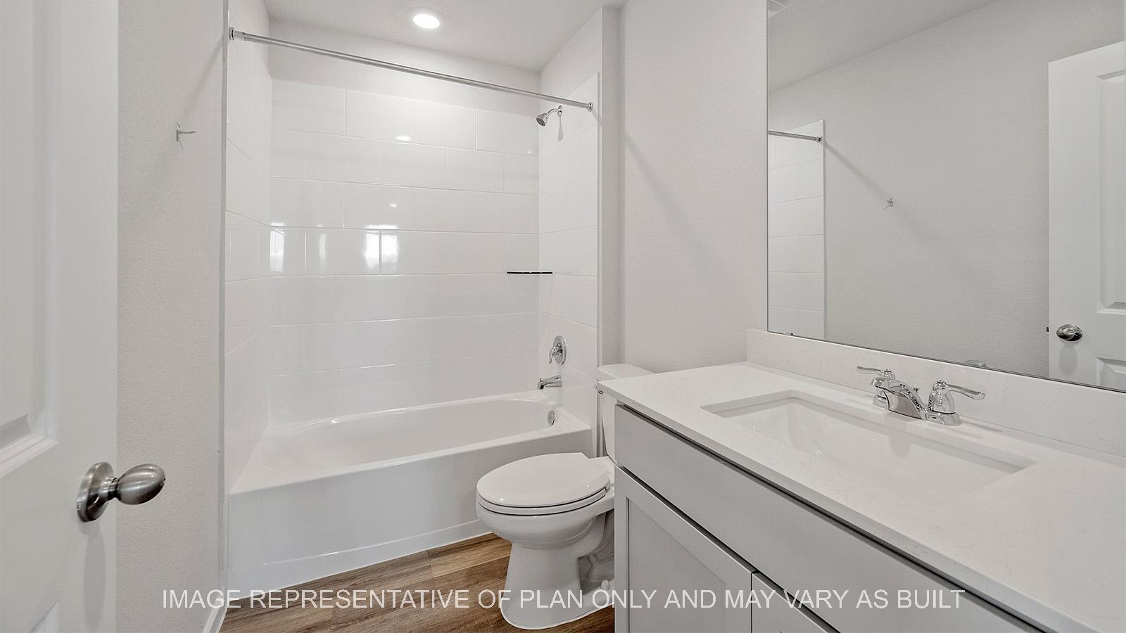 Emma secondary bathroom with vinyl plank flooring, quartz countertop, and ceramic tile shower/tub surround.
