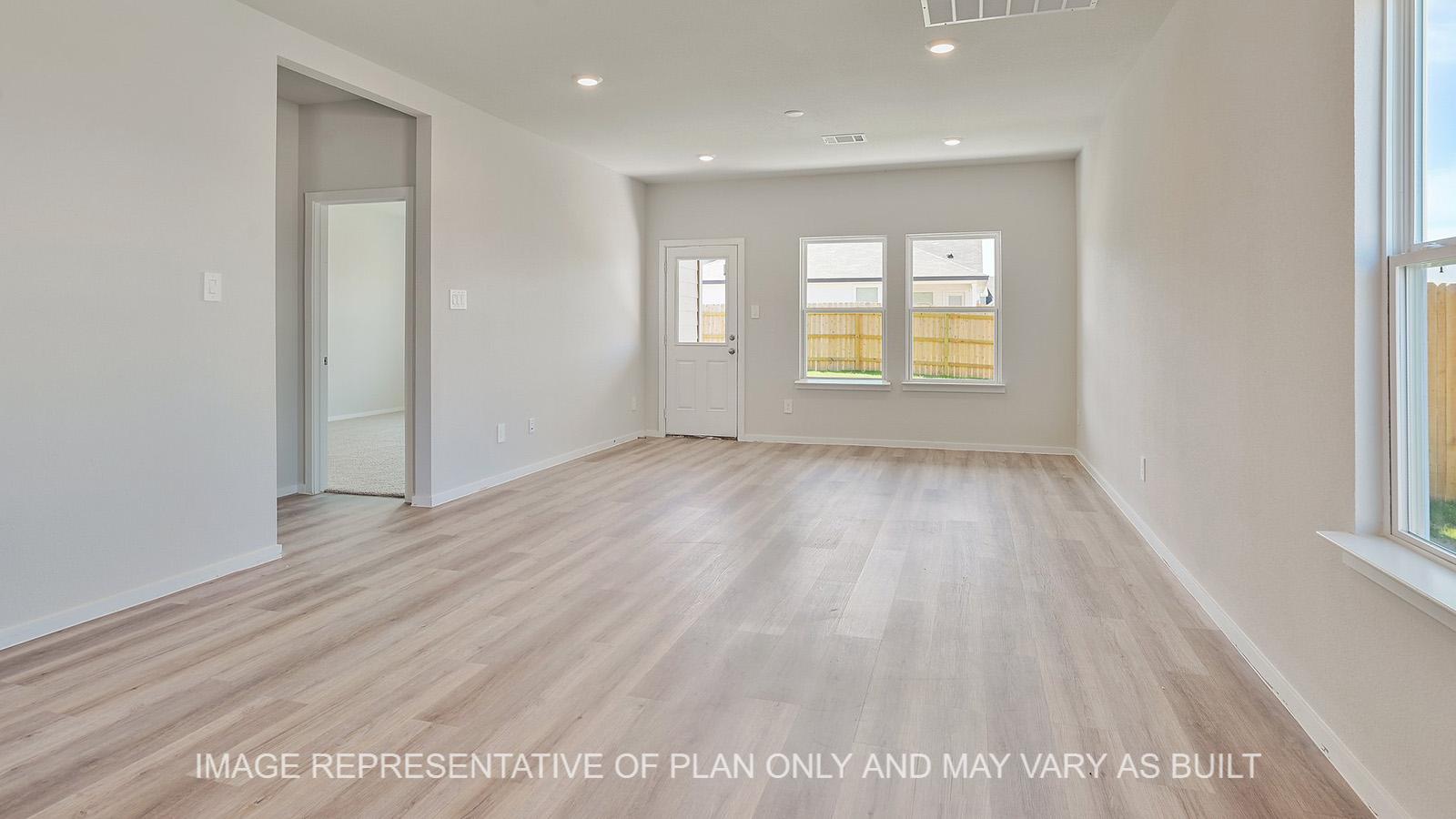 Jasmine open-concept living room with windows, back door, and vinyl plank flooring.