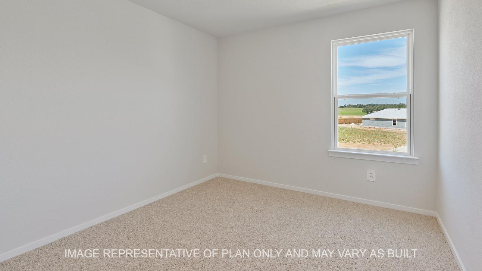 Jasmine secondary bedroom with window and carpeted flooring.