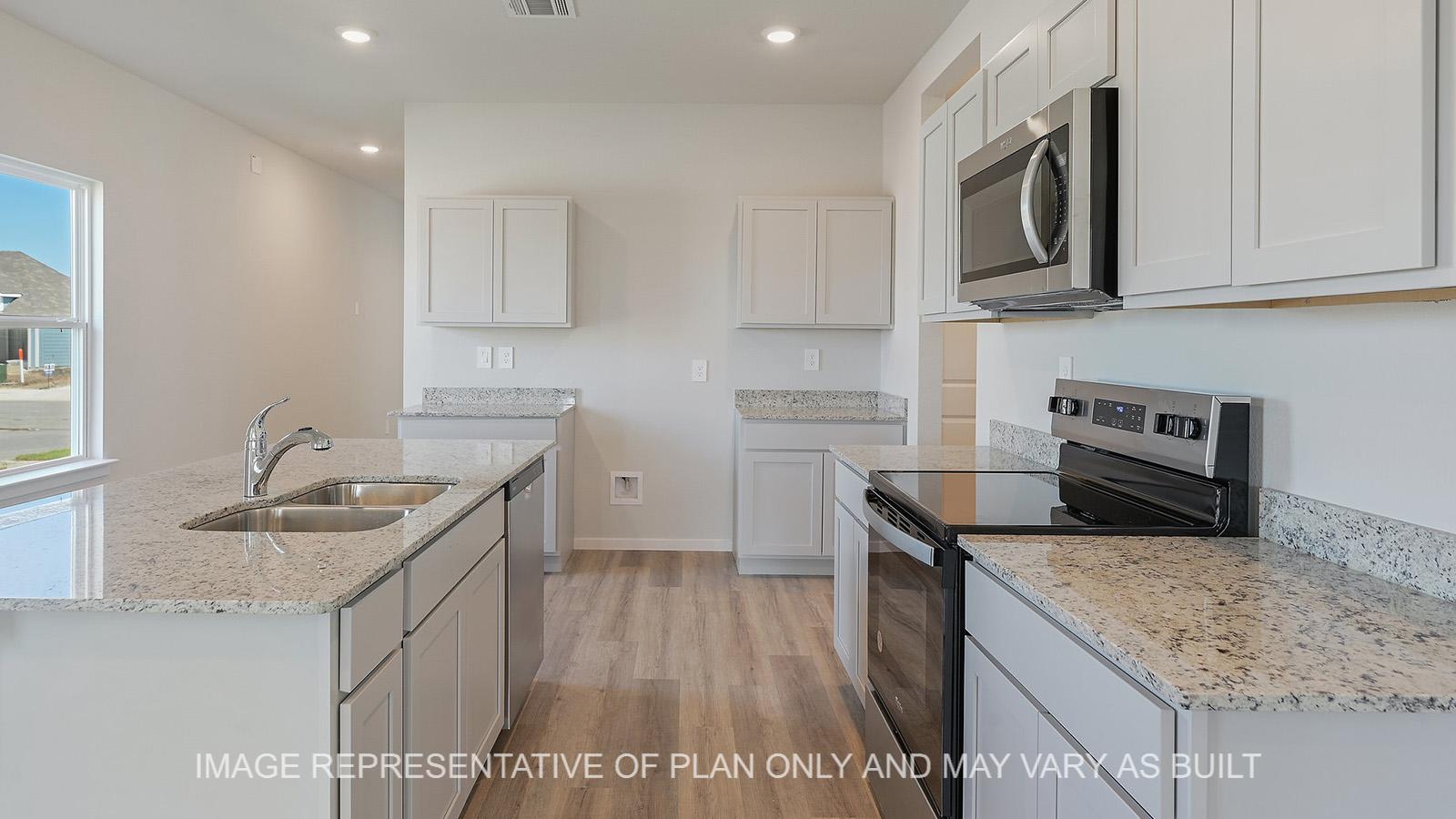 Jasmine kitchen with granite countertops, white cabinetry, and vinyl plank flooring.