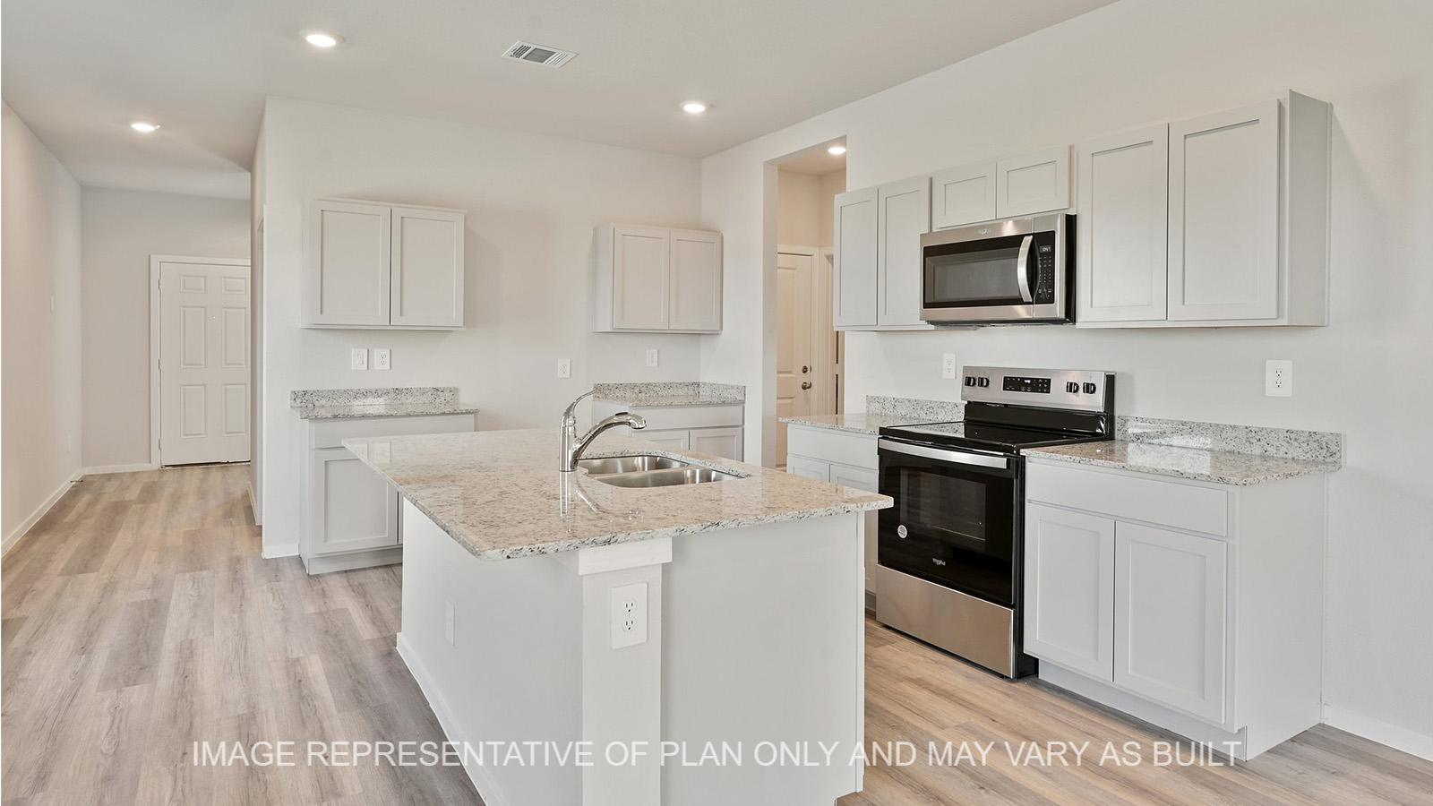 Jasmine kitchen with granite countertops, white cabinetry, and vinyl plank flooring.