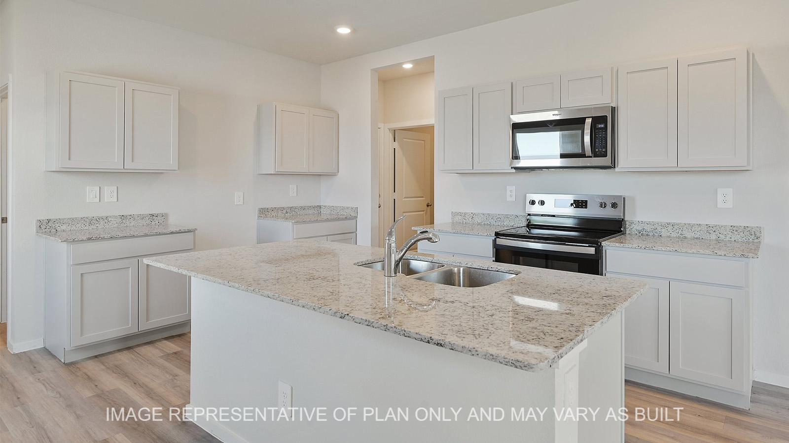 Jasmine kitchen with granite countertops, white cabinetry, and vinyl plank flooring.