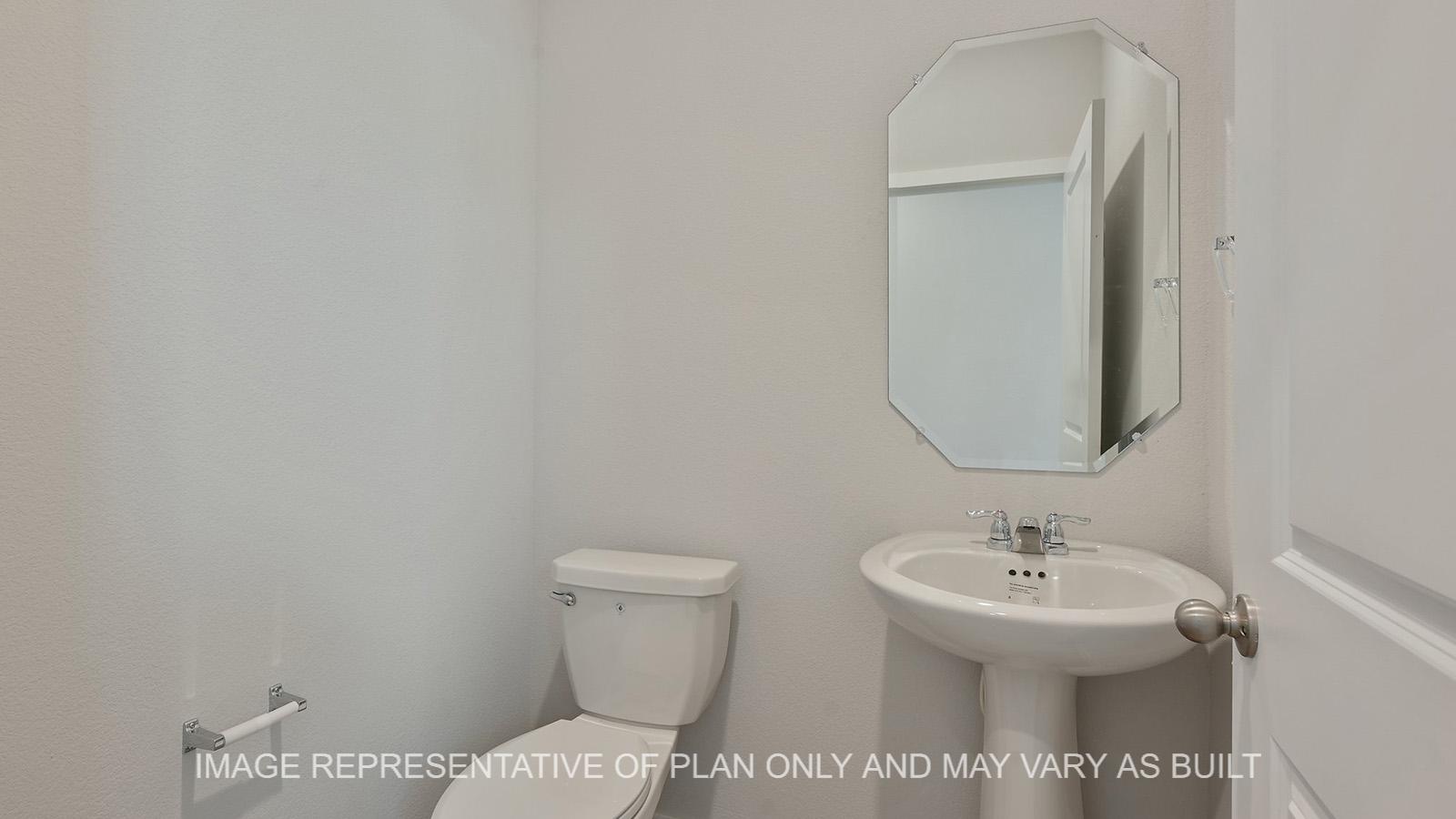 Jasmine powder bath with vinyl plank flooring.