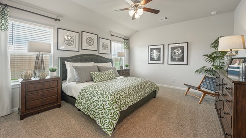 Pleasant Hill Model Home primary bedroom with king size bed and two windows.