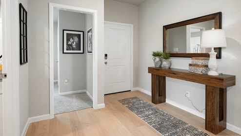 Pleasant Hill Model Home entryway with wood console and floor runner.