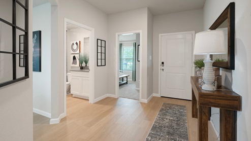Pleasant Hill Model Home foyer with access to secondary rooms and bathroom.
