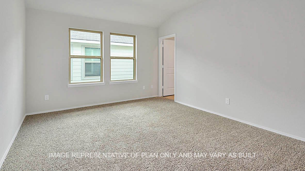 Ashburn primary bedroom with carpeted flooring, windows, and bathroom.