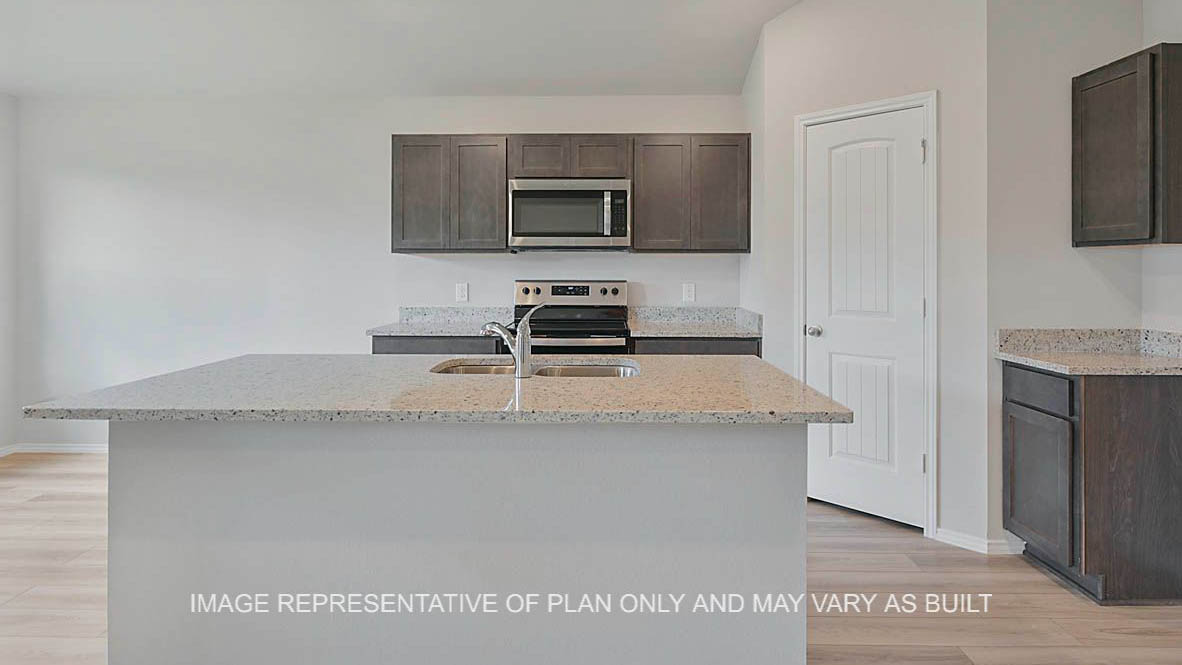 Ashburn kitchen with stained cabinetry, granite countertops, vinyl plank flooring, island and pantry.