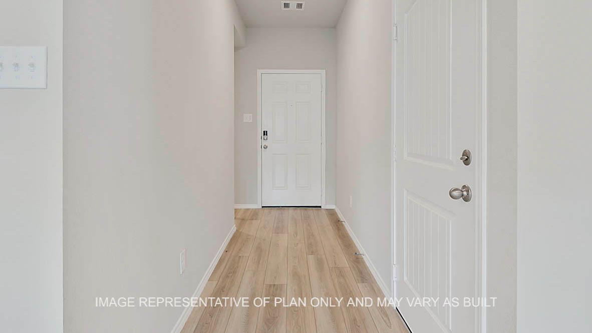 Ashburn entryway with vinyl plank flooring and front door.