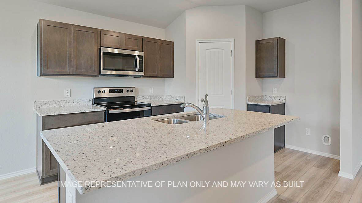 Ashburn kitchen with stained cabinetry, granite countertops, vinyl plank flooring, island and pantry.