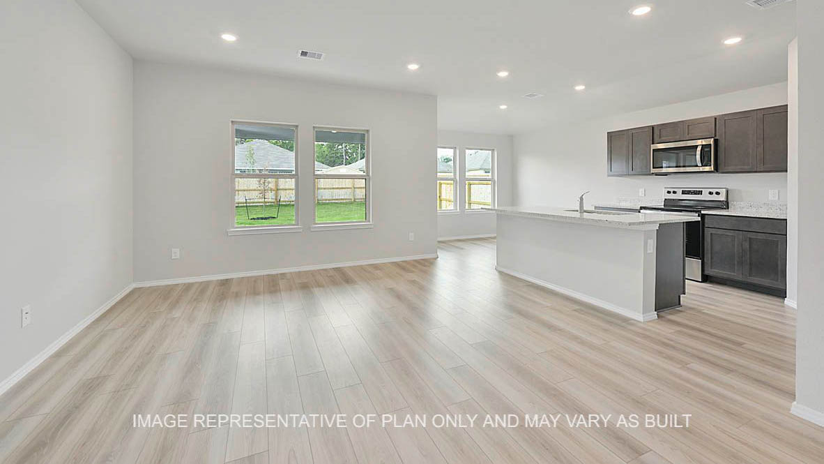 Ashburn open-concept living room with windows, vinyl plank flooring, and view to kitchen and dining.