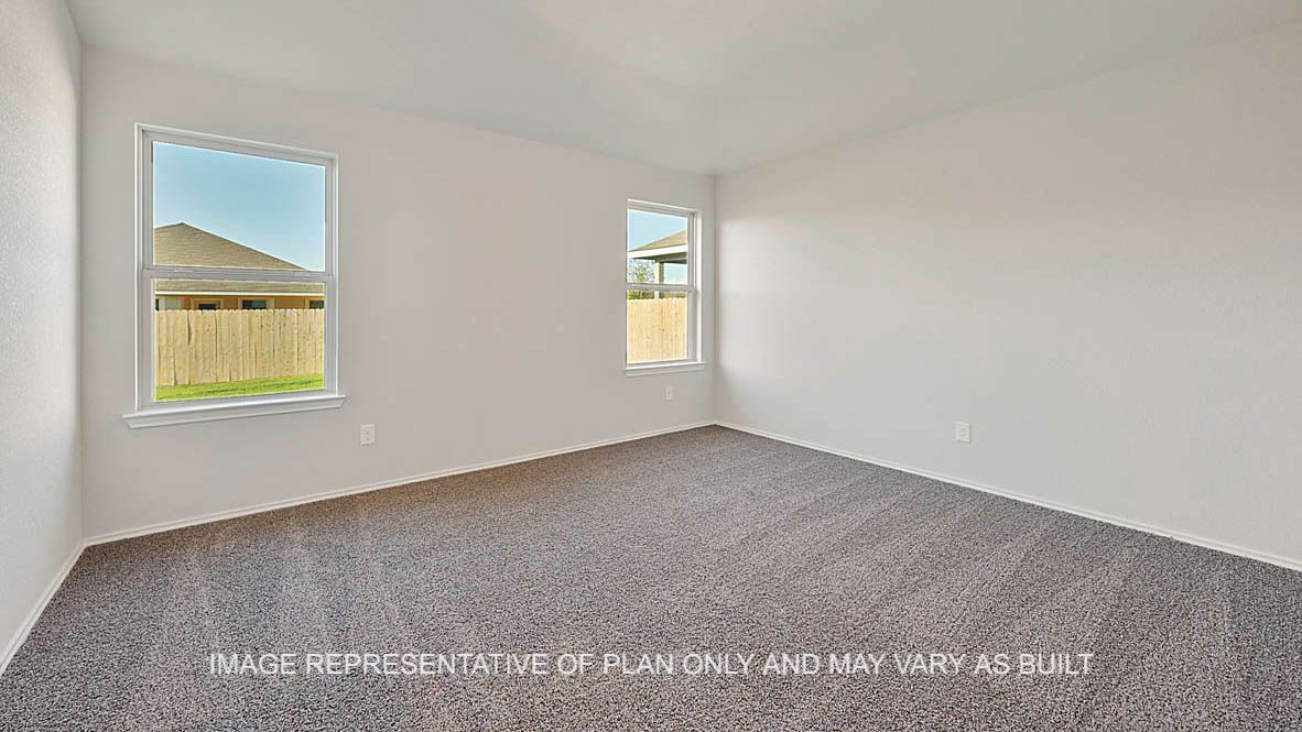 Bellvue primary bedroom with windows and carpeted flooring.