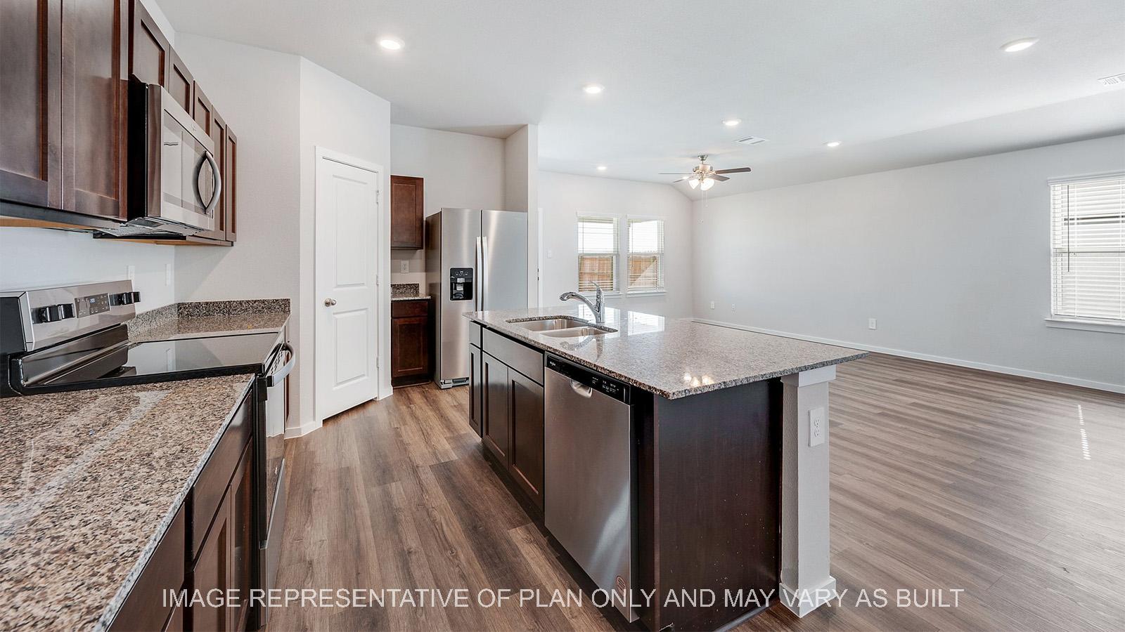 Camden kitchen with granite countertops, island, and vinyl plank flooring.