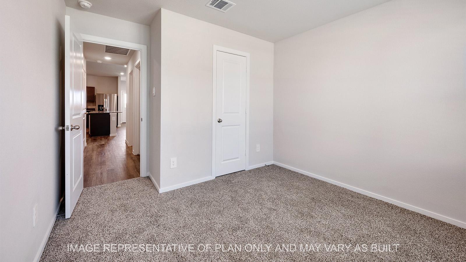 Camden secondary bedroom with carpeted flooring and closet.