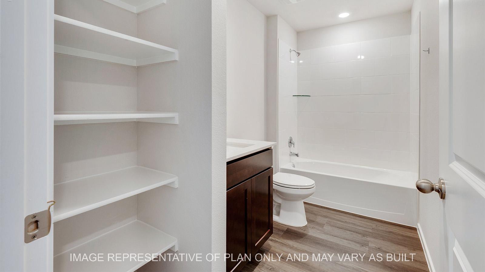 Camden secondary bathroom with linen shelving.