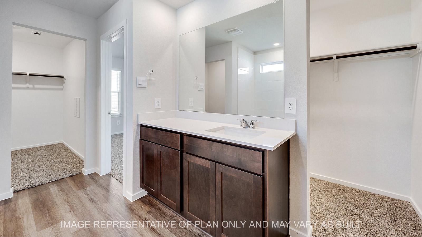 Camden primary bathroom with two walk-in closets.