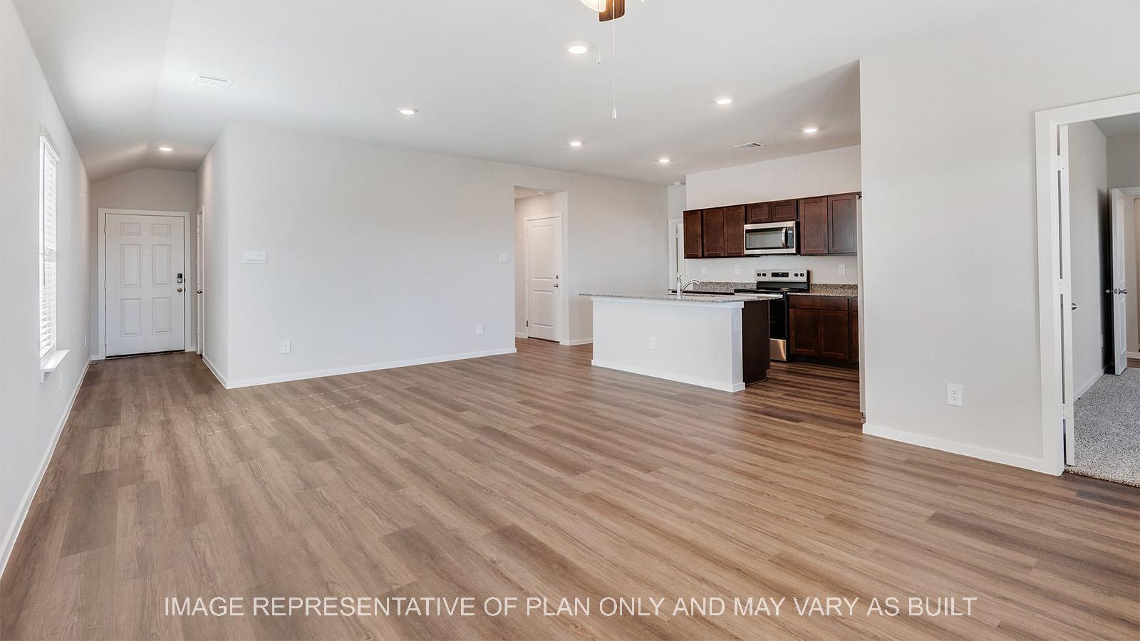 Camden open-concept living room with vinyl plank flooring and view to kitchen.