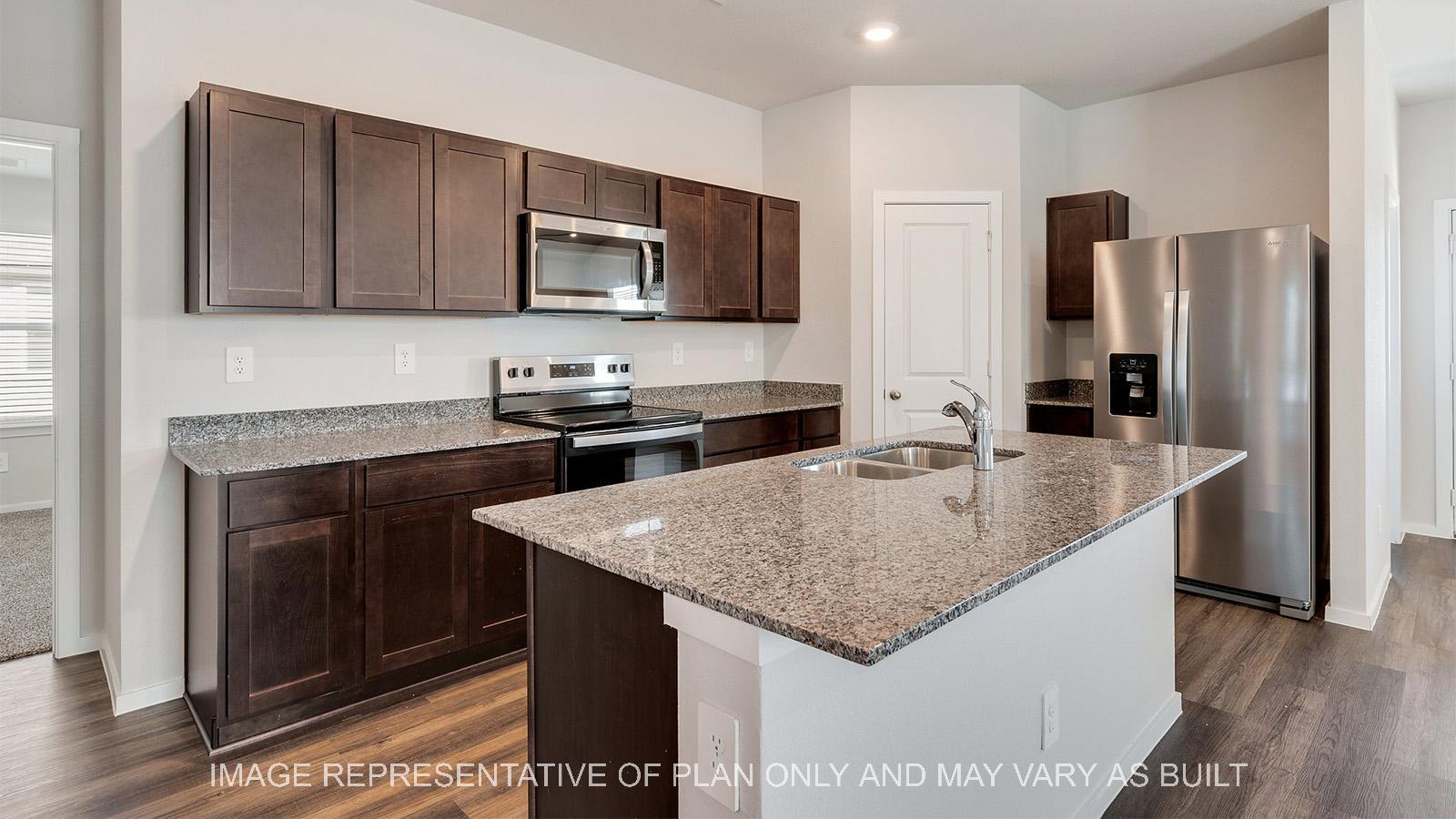 Camden kitchen with granite countertops and dark stained shaker cabinetry.