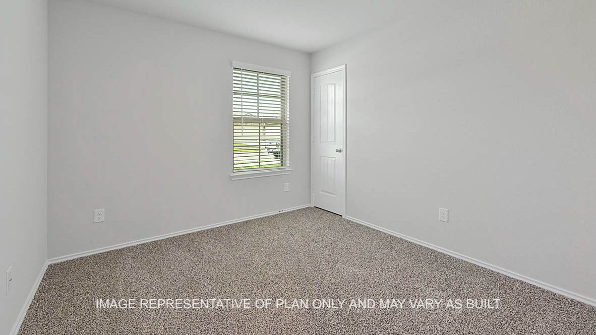Fargo secondary bedroom with window, carpeted flooring, and closet.