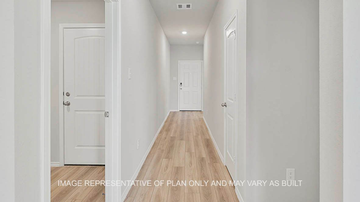 Fargo entry with vinyl plank flooring and view to front door.