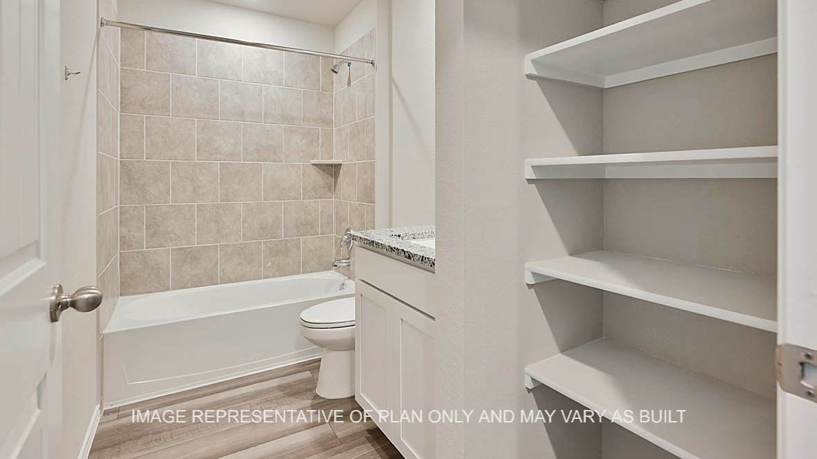 Texas Cali secondary bathroom with white cabinets, granite countertops, ceramic tile shower surround and vinyl plank flooring.